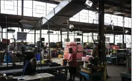  ?? LUKE SHARRETT — BLOOMBERG ?? Workers prepare items for shipping inside a warehouse in Newell, W.VA.