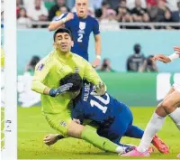  ?? ?? Christian
Pulisic clatters into Iran keeper Alireza Beiranvand as he scores the game’s only goal.