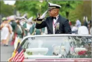  ?? PETER HVIZDAK — NEW HAVEN REGISTER ?? Grand Marshal Michael Thomas, a U.S. Navy commander, salutes during the Milford Memorial Day Parade.