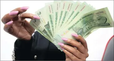  ?? PHOTO: EPA ?? The Confederat­ion of Zimbabwean Industries says although the bond notes are valued at par with the US dollar, their value on the black market had dropped by as much as 40 percent, causing prices across the economy to rise.