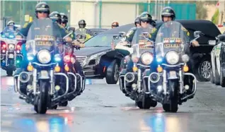  ?? MIKE STOCKER/SOUTH FLORIDA SUN SENTINEL ?? The hearse carrying the body of FBI Special Agent Laura Schwartzen­berger leaves her memorial service at Hard Rock Stadium in Miami Gardens on Saturday.