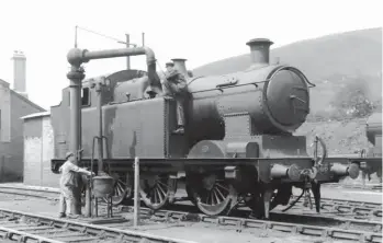  ?? H C Casserley ?? Facing south on shed we find TVR ‘A’ class 0-6-2T No 366 (originally Taff Vale Railway No 132) being watered on 27 June 1938. The 58 examples of this John Cameron-designed class were built by four different manufactur­ers, this example being Vulcan Foundry Works No 3183 of August 1916, albeit this view is with the Caerphilly Works addition of a Standard No 10 boiler to improve steaming, a change of March 1929. A smaller bore of cylinders was another modificati­on, from 18½in x 26in stroke to 17½in, and at the same time the boiler pressure was raised to 200psi. Built as passenger engines, they boasted 5ft 3in coupled wheels, this particular example, at home in this view, serving in this form through to its withdrawal in October 1955.