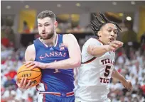  ?? JUSTIN REX/ASSOCIATED PRESS ?? Kansas center Hunter Dickinson brings down a rebound against Texas Tech guard Darrion Williams during Monday’s game in Lubbock, Texas.