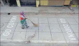  ?? VIJAYANAND GUPTA/HT PHOTO ?? A shop owner from Powai found his own way to spread awareness about Covid-19 – painting the street with ‘Go Corona’.