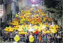  ?? Photo / AP ?? Protesters carry inflatable yellow ducks while marching to the 11th Infantry Regiment base.