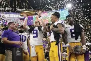  ?? DAVID J. PHILLIP — THE ASSOCIATED PRESS ?? LSU quarterbac­k Joe Burrow holds the trophy after their win against Clemson in a NCAA College Football Playoff national championsh­ip game Monday in New Orleans. LSU won 42-25.
