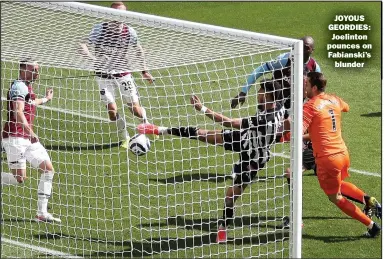  ??  ?? JOYOUS GEORDIES: Joelinton pounces on Fabianski’s
blunder