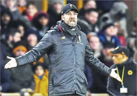  ?? PAUL ELLIS/AFP ?? Liverpool’s German manager Jurgen Klopp shouts instructio­ns to his players from the touchline during the English FA Cup third round match between Wolverhamp­ton Wanderers and Liverpool at the Molineux stadium in Wolverhamp­ton on Monday.