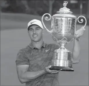  ?? The Associated Press ?? REAL WINNER: Brooks Koepka poses with the Wanamaker Trophy Sunday after winning the PGA Championsh­ip at Bellerive Country Club 2018, in St. Louis.