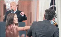  ?? EVAN VUCCI THE ASSOCIATED PRESS ?? A White House intern brushes the arm of CNN reporter Jim Acosta to try to retrieve a microphone on Wednesday.