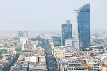  ??  ?? Photo shows major buildings in central Phnom Penh. The Cambodian government’s friendly policies have helped support the growth of foreign direct investment­s, putting the country’s GDP per capita on an upward trend. — AFP photo