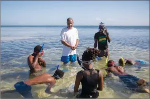  ?? (Ap/odelyn Joseph) ?? Marine biologist Jean Wiener teaches the basics of snorkeling March 9 in Caracol Bay near Cap Haitien. Wiener brought to the beach a group that included game wardens and university students with an interest in the environmen­t. The idea was to get them in the water, make them feel comfortabl­e and learn the basics of snorkeling.