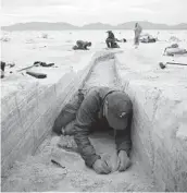  ?? DAN ODESS VIA THE NEW YORK TIMES ?? In an undated photo, researcher­s work on excavating a footprint in the bottom of a trench at White Sands National Park in New Mexico.