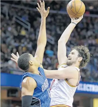  ?? TONY DEJAK/ASSOCIATED PRESS ?? Kevin Love, shooting here over Tobias Harris, had a game- and season-high 34 points as Cleveland beat Orlando for an 11th straight time. After the loss, Magic coach Scott Skiles said there’d be lineup changes.