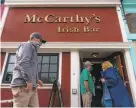  ?? Jungho Kim / Special to The Chronicle ?? Patrons line up to enter McCarthy’s Irish Bar in San Francisco to celebrate St. Patrick’s Day.