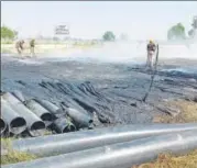  ?? HT PHOTO ?? Firefighte­rs douse flames after farmers allegedly set ablaze a pipe kept in front of power sub station in Unnao on Sunday.