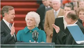  ?? AP FILE PHOTO ?? PROUD DAY: Barbara Bush looks on as her husband is sworn into office as the 41st president of the United States by Chief Justice William Rehnquist on Jan. 20, 1989.