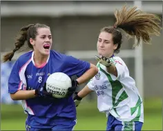  ??  ?? Rachel Armstrong of St Pat’s looks for options as AGB’s Emily Mitchell closes in during the Ladies Junior Football championsh­ip final in Joule Park, Aughrim.