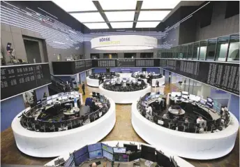  ??  ?? Traders monitor financial data inside the Frankfurt Stock Exchange. The DAX 30 closed 1.2% down at 11,335.32 points yesterday.