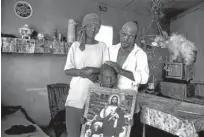  ??  ?? ‘Family on one of the Jonker farms. Running water, electricit­y, TV, the works. The one thing that I did find in Oudtshoorn was that in homes where one found religious icons, things were well with the family. In this case, however, the man was a little drunk. It was the weekend. Only a little drunk and a little sad. The eyes of the child. There is a lot of foetal alcohol syndrome in the Klein Karoo. A school just for these damaged kids at Dysselsdor­p’