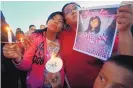  ?? JON AUSTRIA/THE DAILY TIMES ?? Klandre Willie, left, and her mother, Jaycelyn Blackie, participat­e in a candleligh­t vigil for Ashlynne Mike at the San Juan Chapter House in Lower Fruitland in this May 4, 2016, photo.