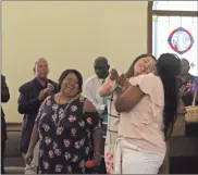  ?? / Diane Wagner ?? Patresia Johnson (center), chair of the Rev. J.L. Vaughn Tracking Scholarshi­p Ministry Program, laughs as recipients Christina McArver and Aa’liyah Linley congratula­te each other on their graduation­s Sunday at Lovejoy Baptist Church.