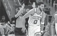  ?? CARLOS OSORIO/AP ?? Celtics forward Jayson Tatum reacts after making a 3-pointer against the Pistons on Monday in Detroit. The Celtics have won three of their last four games.