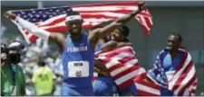  ?? RICH PEDRONCELL­I — THE ASSOCIATYE­D PRESS ?? Eric Futch, front, celebrates with the United States flag after he won the men’s 400-meter hurdles at the U.S. Track and Field Championsh­ips in June. Futch and former Penn Wood teammate Darrell Hill are in London for the IAAF World Championsh­ips,