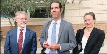  ?? The Associated Press ?? ACQUITTED: Scott Warren, center, of Ajo, Ariz. celebrates with his attorneys Amy Knight, right, and Greg Kuykendall outside court in Tucson, Ariz., on Wednesday after being acquitted of two counts of harboring in a case that garnered internatio­nal attention. Prosecutor­s said Warren illegally helped two migrants avoid authoritie­s. He said he was fulfilling his humanitari­an duties by helping two injured men.