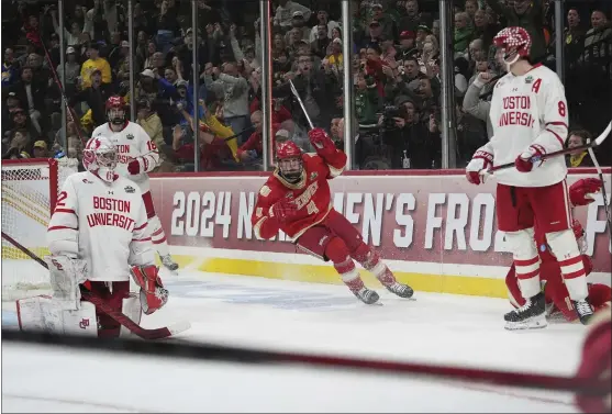  ?? ABBIE PARR — THE ASSOCIATED PRESS ?? Denver forward Jack Devine (4) celebrates after an overtime win against Boston University in a semifinal game at the Frozen Four NCAA college hockey tournament Thursday, April 11, 2024, in St. Paul, Minn.