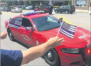  ?? PHOTOS BY PETE BANNAN - MEDIANEWS GROUP ?? Supporters wave flags to police at the ‘Back the Blue’ rally along MacDade Boulevard in Ridley Sunday.