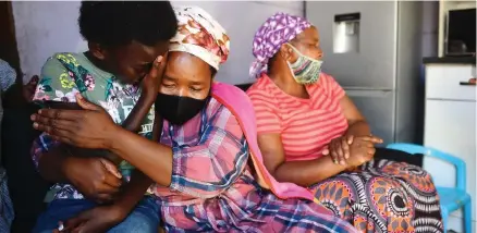  ?? PHANDO JIKELO African News Agency (ANA) ?? TWELVE-YEAR-OLD Musa Mlaza, left, is in tears after her twin brother Nqabayethu died on Monday in Nyanga. Her heartbroke­n mother Lindelwa said her son loved playing with his friends. Next to them on the far right is a neighbour Nondiphe Thonjeni, who provided support to the family. |