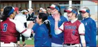  ??  ?? Riley Perryman (left) exchanges a high-five with teammates earlier this season.