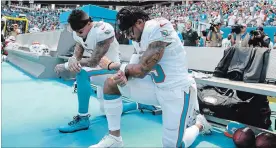  ?? WILFREDO LEE
THE ASSOCIATED PRESS ?? Dolphins Kenny Stills, left, and Albert Wilson kneel during the playing of the U.S. national anthem before a game against the Tennessee Titans on Sunday in Miami Gardens, Fla.