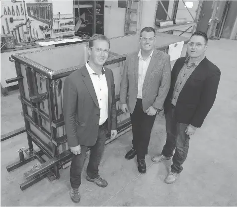  ?? TROY FLEECE ?? From left: Sean Frisky, CEO of Ground Effects Environmen­tal, John Miller, COO of Living Sky Water Solutions Inc., and Ryan Van Dijk, CEO of Living Sky Water Solutions Inc., stand in front of a reactor vessel at Ground Effects Environmen­tal in Regina.