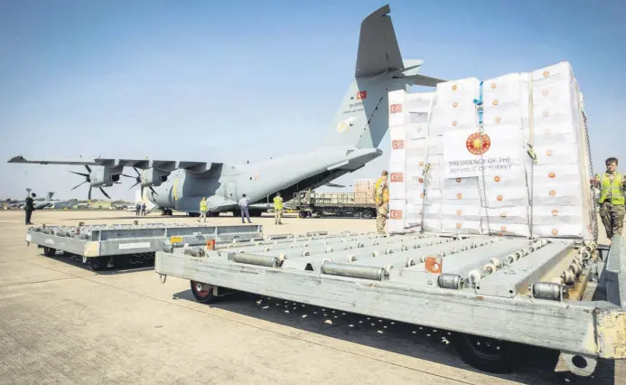  ??  ?? Crucial supplies of personal protective equipment (PPE) for medical staff are delivered from Turkey to a Royal Air Force base for distributi­on around the country, amid the coronaviru­s outbreak, in Carterton, Britain, April 10, 2020.