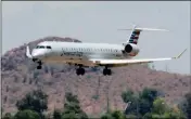  ?? ASSOCIATED PRESS ?? AN AMERICAN EAGLE JET IS SEEN THROUGH HEAT RIPPLES AS IT LANDS AT SKY HARBOR Internatio­nal Airport on Monday in Phoenix. American Airlines canceled dozens flights out of Phoenix on Monday due to extreme heat. The cancellati­ons were for operations by...