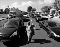  ?? AP Photo/Marcio Jose Sanchez ?? In this May 15 file photo, cars line up at a food distributi­on center in Compton, Calif.