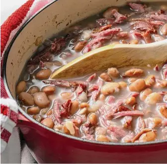  ?? Scott Suchman/for the Washington Post ?? Smoked pork neck bones and pinto beans are the top choice, but this recipe, true to its humble roots, can be made with other types of smoked meat or beans you may have on hand.