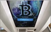  ?? CHARLES KRUPA — THE ASSOCIATED PRESS FILE ?? The Bitcoin logo appears on the display screen of a cryptocurr­ency ATM at a store in Salem, N.H.