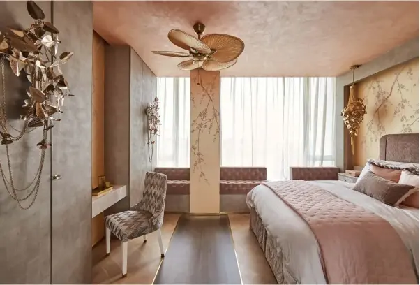  ??  ?? ABOVE The gold punkah fan on the ceiling and plum blossom motifs hark to the homeowner’s Chinese heritage OPPOSITE PAGE The same floral wallpaper is used in the bedroom and bathroom to create a cohesive look; the glamorous dressing room features...