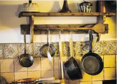  ?? GETTY IMAGES/ISTOCKPHOT­O ?? If you’re short on cabinet and drawer space, consider hanging pots from a wall-mounted or ceiling-mounted pot rack.