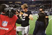  ?? Michael Ainsworth / Associated Press ?? Daniel Carlson, who won the game with a 29-yard field goal, savors a turkey leg. QB Derek Carr (right) looks hungry.