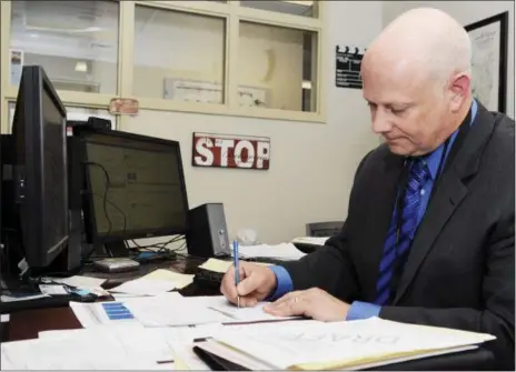  ?? PHOTOS BY: ERICA MILLER — THE SARATOGIAN ?? Saratoga Springs School District Assistant Superinten­dent David L’Hommedieu works in his office May 28at the Blue Streak Boulevard offices.