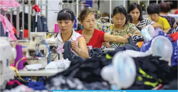  ?? — AFP ?? JINJIANG: Workers at a swimwear factory in Yinglin town in Jinjiang, in China’s eastern Fujian Province.