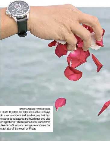  ?? MARIANA/AGENCE FRANCE-PRESSE ?? FLOWER petals are released as the Sriwijaya Air crew members and families pay their last respects to colleagues and loved ones who died on flight SJ182 which crashed after takeoff from Jakarta on 9 January, during a ceremony at the crash site off the coast on Friday.