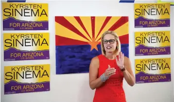  ?? Associated Press ?? ■ Rep. Kyrsten Sinema, D-Ariz., talks to campaign volunteers Aug. 28 at a Democratic campaign office in Phoenix. As the November elections near, Democrats are focusing on health care. It's been a constant drumbeat since the GOP launched its effort to repeal the Obama-era health law and is the subject of the greatest share of political ads on television now. It's a top issue in campaigns from Virginia to Nebraska to California, and especially in Arizona, where Democratic Rep. Kyrsten Sinema has made it the foundation of her Senate campaign.