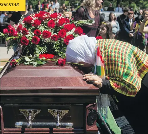  ?? TYLER ANDERSON / NATIONAL POST ?? A Kurdish woman pauses by the casket during the funeral Wednesday of Nazzareno Tassone, who was killed just before Christmas while fighting against ISIL in Syria. After months of being held with enemy fighters, Tassone’s body was finally returned to...