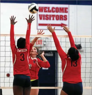  ?? RANDY MEYERS — THE MORNING JOURNAL ?? Bianca Inman of Firelands taps the ball over Nya Grady-Norman of Oberlin at the net.