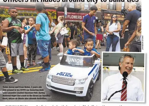  ??  ?? Twins Aaron and Evan Rolon, 3 years old, ride around in toy NYPD car honoring slain teen Lesandro (Junior) Guzman-Feliz during National Night Out event in the Bronx on Tuesday. Inset, Mayor de Blasio also attends festivitie­s.